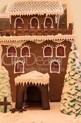 Gingerbread house with white icing and heart shaped windows with