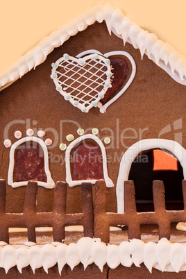 Gingerbread house with white icing and heart shaped windows with