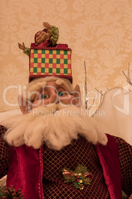 Santa Clause ornament on a Christmas tree with white lights