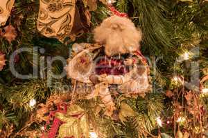 Santa Clause ornament on a Christmas tree with white lights