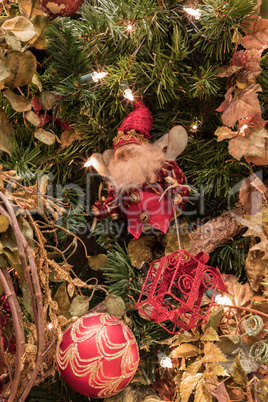 Santa Clause ornament on a Christmas tree with white lights