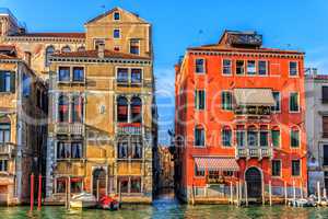 Old venetian palaces and a narrow street channel or rio between
