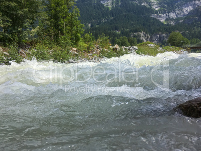 Rough mountain river in the Swiss Alps, Grindelwald, Europe.