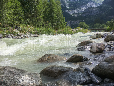 Rough mountain river in the Swiss Alps, Grindelwald, Europe.