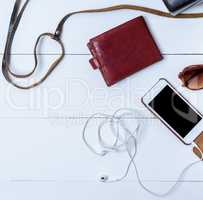 smartphone with a blank black screen, brown leather wallet