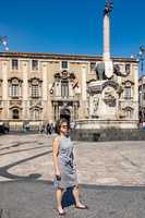 Woman in front of elephant fountain in Catania. Sicily
