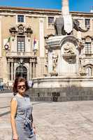 Woman in front of elephant fountain in Catania. Sicily