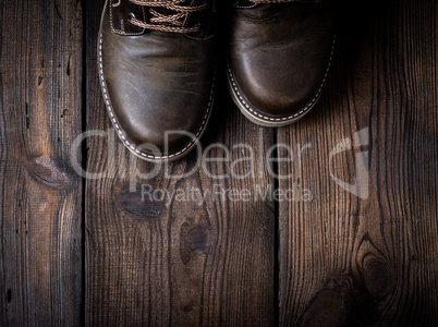 pair of leather brown shoes on a wooden background