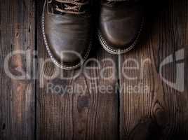 pair of leather brown shoes on a wooden background