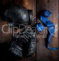 pair of very old black leather boxing gloves