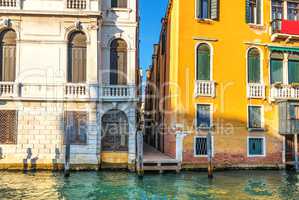 Narrow Venice street between two palaces on the bank of the Gran