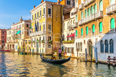 A gondolier in his gondola in the Grand Canal of Venice in front