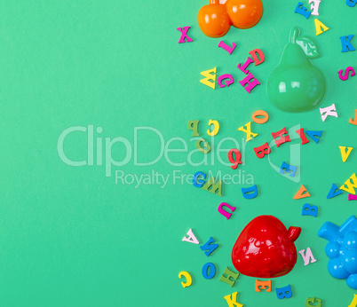 green background with childrens plastic toys
