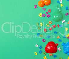 green background with childrens plastic toys