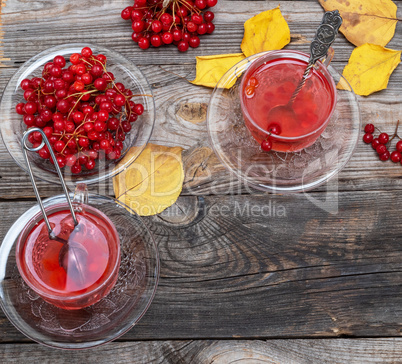 tea from fresh berries of viburnum in a transparent glass cup