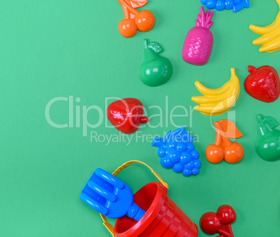 plastic childrens toys in the form of fruit and a bucket