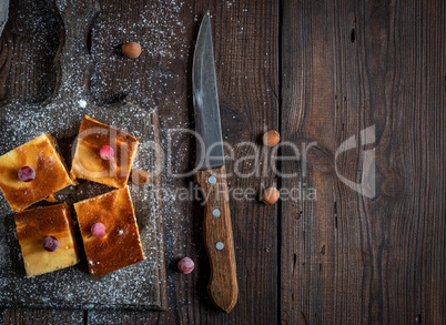 pieces of cheesecake with pumpkin on brown wooden cutting board