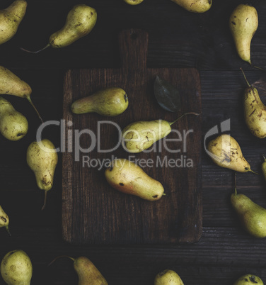 fresh ripe yellow pears on a brown wooden table