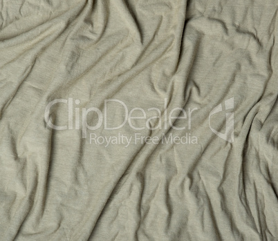 green crumpled cotton stretching soft fabric, full frame