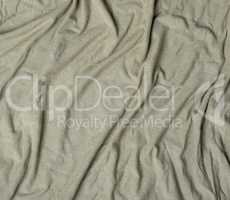 green crumpled cotton stretching soft fabric, full frame