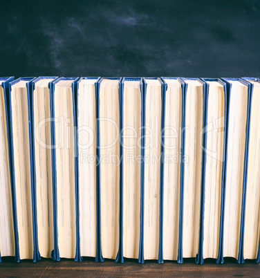 many books on a brown wooden table