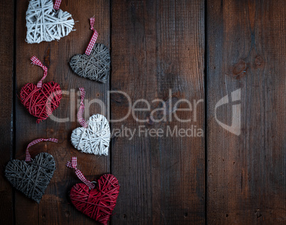wicker hearts on a brown wooden plank background