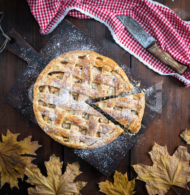 Baked whole round apple pie , wooden table, top view