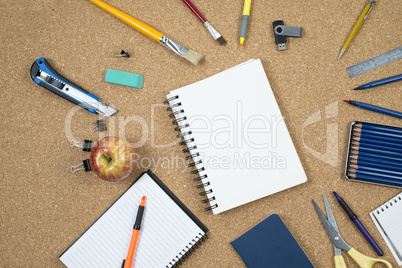 School elements on cork background with space for text symbolizing back to school