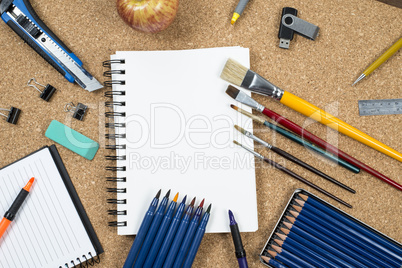 School elements on cork background with space for text symbolizing back to school