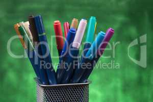 Creativity of Colorful Colored Pen in Pencil Case with Copy Space on Blurred Bokeh green Background
