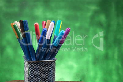 Creativity of Colorful Colored Pen in Pencil Case with Copy Space on Blurred Bokeh green Background