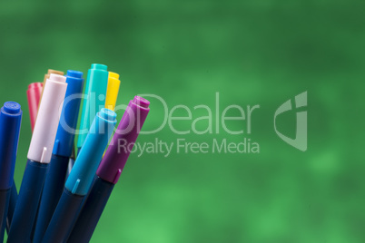 Creativity of Colorful Colored Pen in Pencil Case with Copy Space on Blurred Bokeh green Background