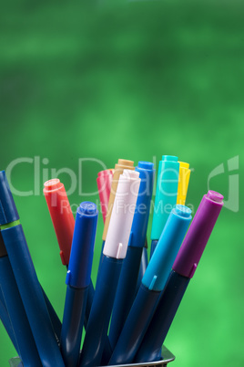 Creativity of Colorful Colored Pen in Pencil Case with Copy Space on Blurred Bokeh green Background