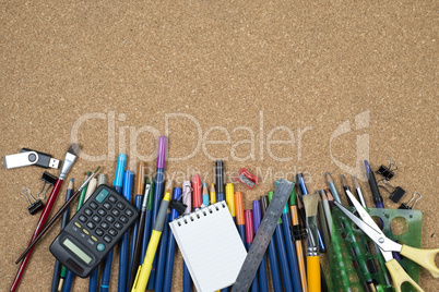 various stationery, arranged on the underside of a cork