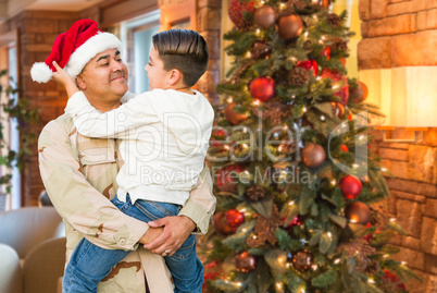 Hispanic Armed Forces Soldier Wearing Santa Hat Hugging Son