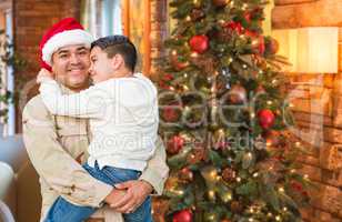 Hispanic Armed Forces Soldier Wearing Santa Hat Hugging Son