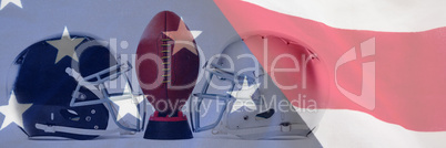 Composite image of close up of american football on tee by sports helmets