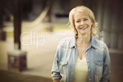 Senior woman smiling outside her house