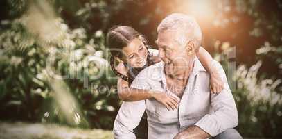 Grandfather and granddaughter playing at yard