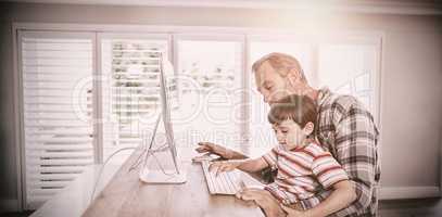 Father and son working on computer