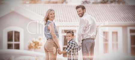 Parents and son standing in garden