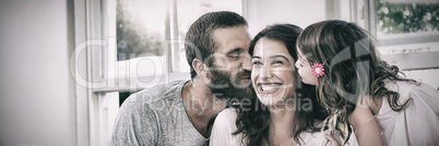 Mother receiving gift from her daughter and husband