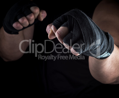 two men's hands rewound with a black textile band