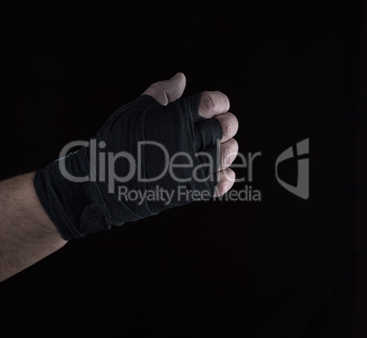 male right hand is wrapped in a black sports textile bandage