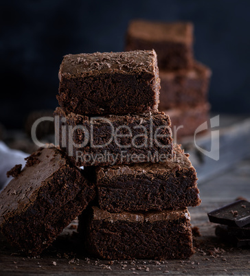 stack of square pieces of baked brown brownie pie