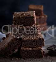 stack of square pieces of baked brown brownie pie