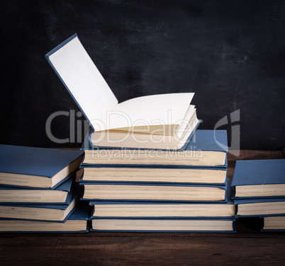 stack of various books, open book on top