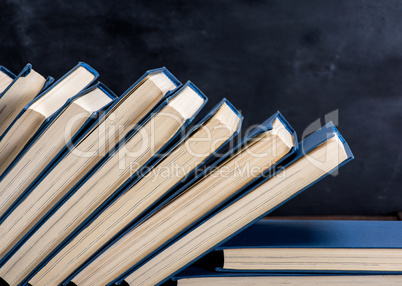 uneven pile of books in the blue cover