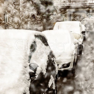 Parked cars in the street in winter