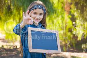 Cute Young Mixed Race Girl With Okay Sign Holding Blank Blackboard